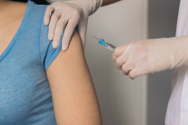 nurse giving a vaccine to a patient.