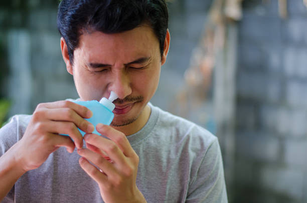 clean sinus asian man clean sinus saline stock pictures, royalty-free photos & images